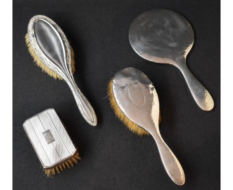An Edwardian two-piece silver dressing table set, comprising a hairbrush and mirror having planished decoration, marks for Ch