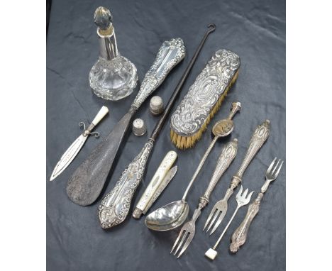 An assortment of silver and silver mounted items, including a sword motif book mark with mother-of-pearl handle, in reference