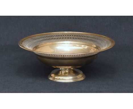 A George V silver dish of circular form, having a wide flared rim with pierced decoration, with a circular step moulded foot,