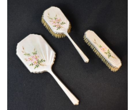 An Elizabeth II three-piece silver dressing table set having white guilloch enamel and floral decoration comprising a mirror,