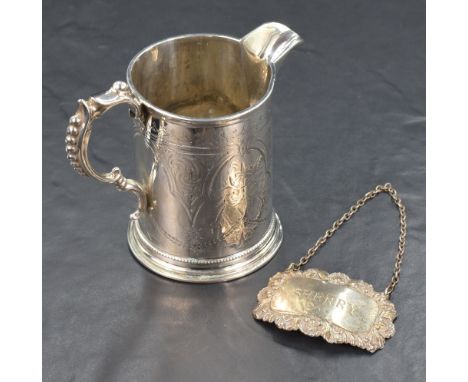 A Victorian silver tankard style jug, of cylindrical form having a narrow pointed rim opposed by a scroll and bead handle, wi