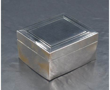 A George V silver cigarette box, of hinged rectangular form with engine-turned decoration to the lid, with wooden lined inter