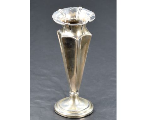 A late Victorian silver weighted vase, having a flared conforming rim and concave geometric tapered body on a step moulded ci