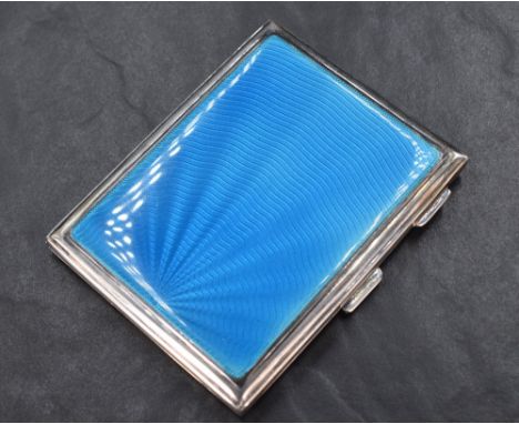 A George V silver cigarette case of rectangular engine turned form having blue guilloche enamel to the top, marks for London 