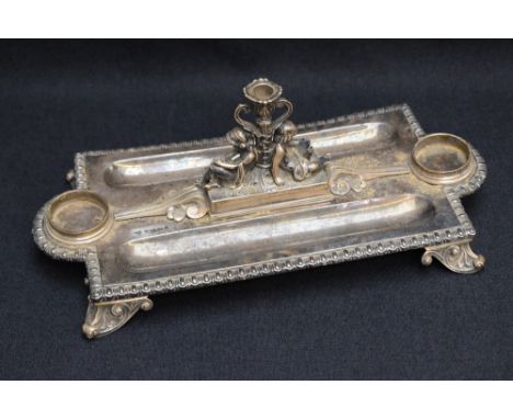 A Victorian silver inkstand, of rectangular form, with egg-and-dart moulded rim, lobed inkwell apertures to each end and two 