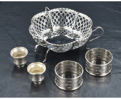 A silver bon bon dish of conforming lobed form, having a beaded rim and pierced design with three scroll handles also acting 