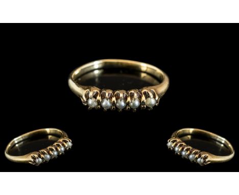 An Antique Gold Ring set with five seed pearls, stamped 14k.  Size M.