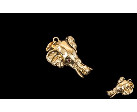 14ct Gold Elephant Pendant, trunk turned up, with ruby eyes. Fully hallmarked.  Weight 4.5 grams.