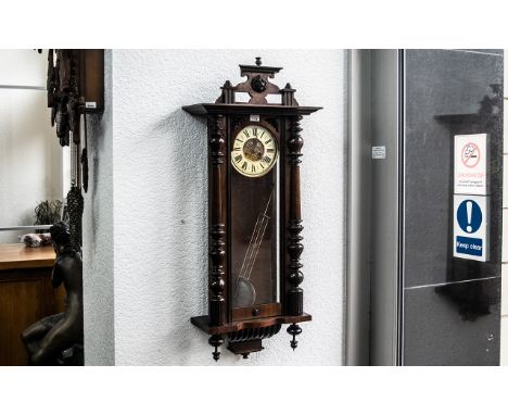 Vienna Wall Clock with glazed front and sides, cream chapter dial with Roman numerals, pendulum driven, Mahogany finish. Appr