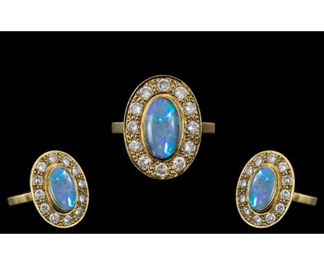 18ct Gold - Stunning Black Opal and Diamond Set Dress Ring. The Oval Shaped Black Opal of Top Quality, Est 2.00 cts. Surround