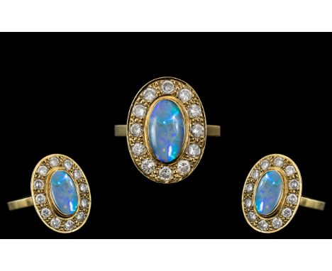 18ct Gold - Stunning Black Opal and Diamond Set Dress Ring. The Oval Shaped Black Opal of Top Quality, Est 2.00 cts. Surround