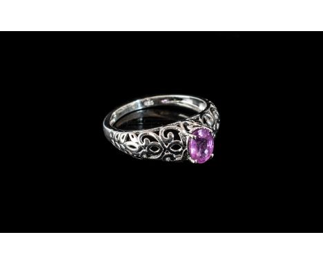 Pink Sapphire Solitaire Ring, size Q; a pink sapphire of just over 1ct, oval cut and set in an openwork, platinum vermeil and