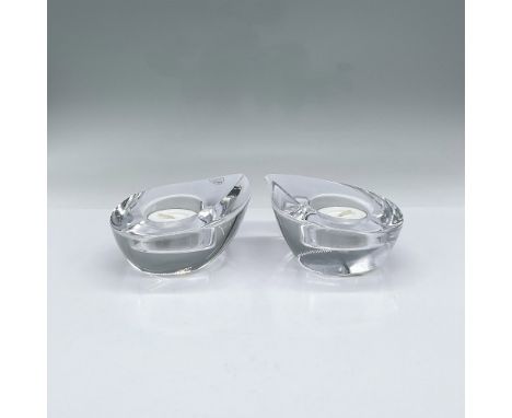 Pair of clear crystal candle holders in the shape of a rain drop. Orrefors mark. Includes original boxes 4.5"L x 4.5"W x 2.25