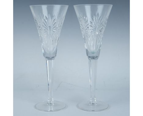 Two tall stunning cut crystal flutes with starburst patterns around the fluted bowl. Waterford mark. This item has its origin