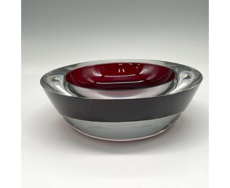 Substantial deep red crystal with clear crystal base with low concave in center. Orrefors mark. Dimensions: 2"H x 6.25" dia. 