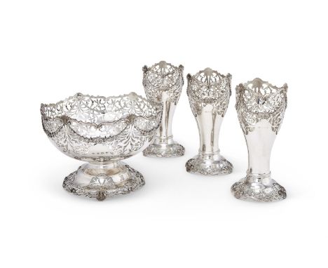 A SILVER SHAPED CIRCULAR PIERCED PEDESTAL ROSE BOWL AND THREE VASES ADIE BROTHERS LTD., BIRMINGHAM 1928 With scroll and shell