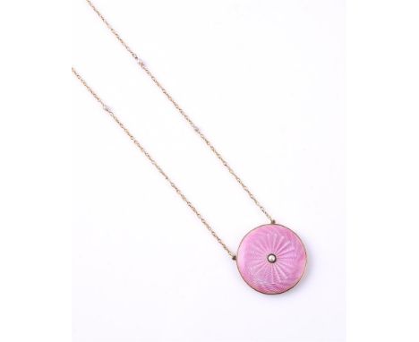 AN EDWARDIAN PINK ENAMEL AND SEED PEARL NECKLACE The circular pink guilloche enamel locket pendant, with central seed pearl a