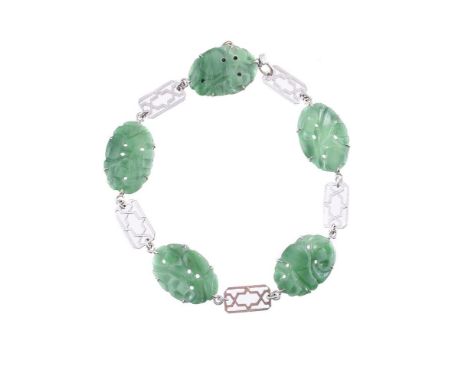 A MID 20TH CENTURY JADEITE JADE BRACELET The oval jadeite jade panels with pierced and carved decoration, with pierced geomet