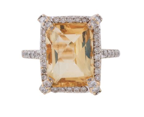 A CITRINE AND DIAMOND CLUSTER DRESS RING The mixed cut citrine within a surround of brilliant cut diamonds, with four brillia