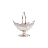 A GEORGE III SILVER NAVETTE SWING HANDLED PEDESTAL BASKET