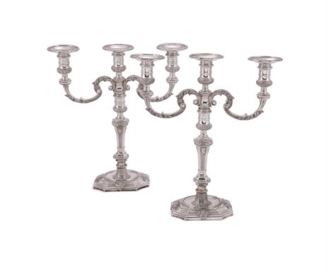 A PAIR OF SILVER THREE LIGHT CANDELABRA  WAKELY & WHEELER, LONDON 1979 With circular sconces, reel capitals and twin foliate 