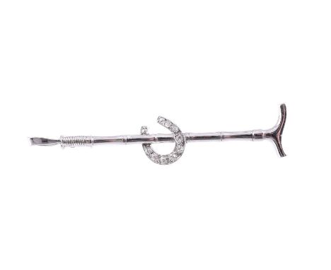 A MID 20TH CENTURY DIAMOND SET RIDING CROP AND HORSE SHOE STOCK PIN  The central horse shoe set with eight cut diamonds, appr