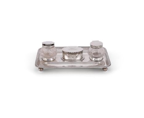 A SILVER OBLONG INKSTAND JOHN GRINSELL & SONS, BIRMINGHAM 1911 With a reeded border, two pen trays, an oval hinged compartmen