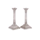 A PAIR OF VICTORIAN SILVER CORINTHIAN CANDLESTICKS