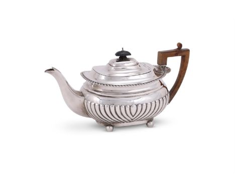 A VICTORIAN SILVER OBLONG BALUSTER TEA POT EDWARD BARNARD & SONS LTD., LONDON 1899 With a wooden oblong finial and harp handl