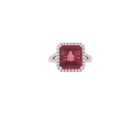 A DIAMOND AND PINK TOURMALINE CLUSTER RING  The step cut tourmaline with canted corners, within a surround of brilliant cut d