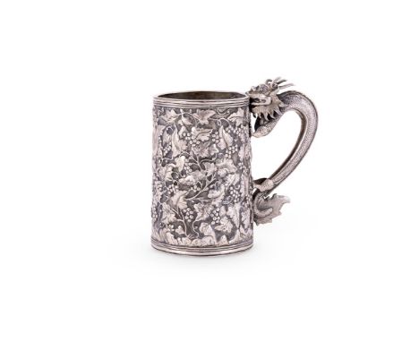 A CHINESE SILVER EXPORT MUG MARKS OBSCURED With a dragon scroll handle, chased with grape vine decoration and engraved with a