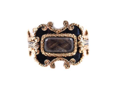 A GEORGE IV BLACK ENAMELLED 18 CARAT GOLD MOURNING RING  LONDON 1829 The shaped and scrolled panel with black enamel and cent