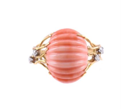 Y&nbspA CORAL AND DIAMOND DRESS RING  LONDON 1980 The striated oval carved coral within an undulating 18 carat gold wire surr