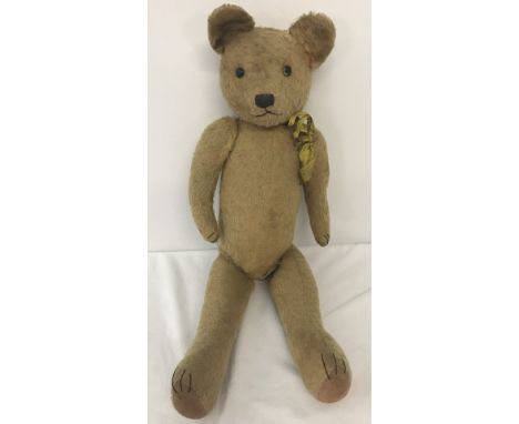 A 1930's  straw filled, blonde haired, jointed Teddy bear possibly Pintel. With old shoe button eyes, large ears and long nos