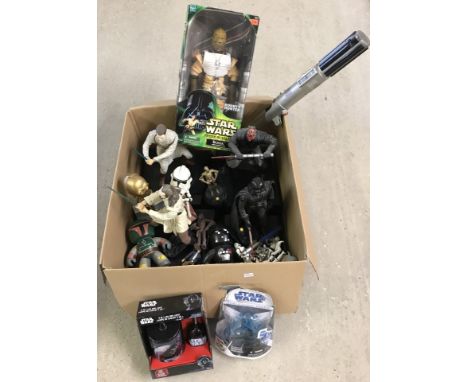 A collection of boxed and unboxed Star Wars toys, figures and light sabre. To include interactive money boxes, bobble heads a