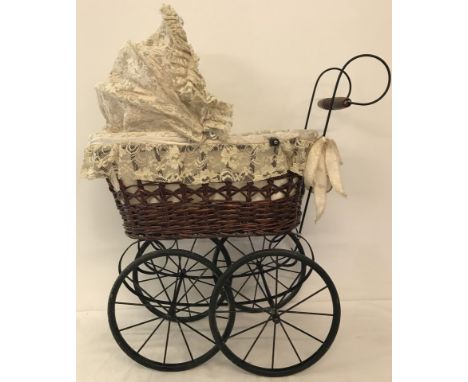 A reproduction vintage style basket body and lace hood dolls pram.  