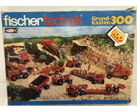 A vintage boxed Fischertechnik construction set complete with instruction booklet and parts list. Grund-Kasten 300, made in W