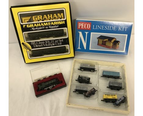 A box of N gauge railway locos, trucks and Lineside kit. Comprising:- a boxed Graham Farish GWR 0-6-0 Tank locomotive, a boxe