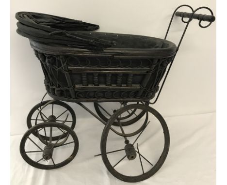 A vintage wooden framed dolls pram. 2 wheels in need of attention. 