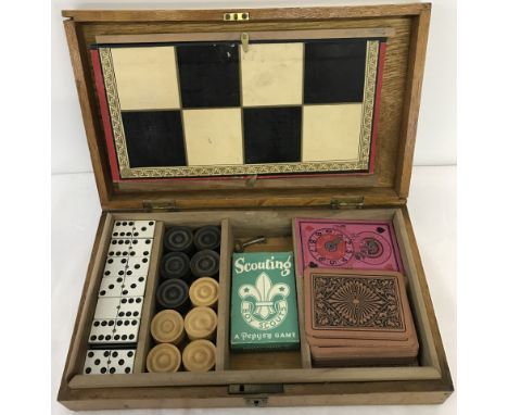 An vintage wooden cased games compendium. To include Pepys Scouting cards 1950's and Chad Valley snap, possibly Edwardian. 
