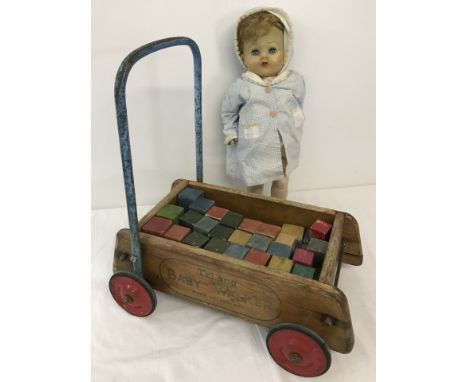 A vintage Tri-ang Baby walker with coloured wooden bricks, & a vintage 'walker' doll. Doll un-named, hard plastic body & viny