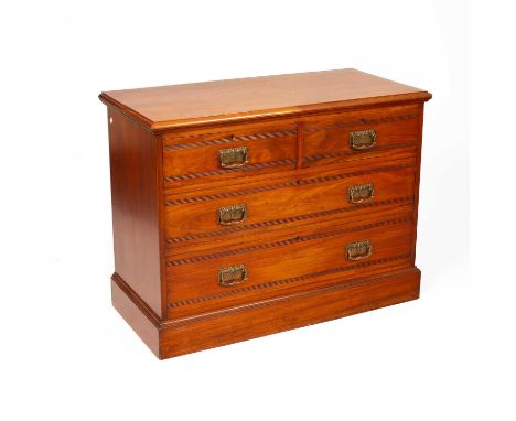 Manner of Harris Lebus, an Arts &amp; Crafts walnut low chest of drawers with two short and two long drawers applied with Art