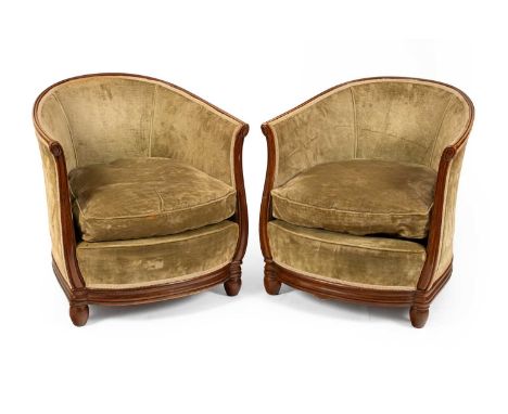 Heal's Ltd. circa 1925-30, a pair of beech framed tub chairs in the manner of Paul Follot, the upholstered frames of semi-cir