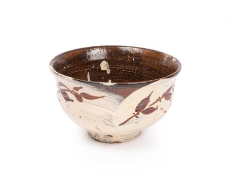 Jim Malone (born 1946), a brown glazed bowl with brushed cream slip decorated foliage and berries, 18cm diameter