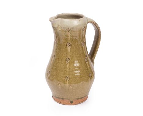 ARR Jim Malone (born 1946) a stoneware jug in an olive green drip glaze with impressed cross decoration to body, maker's mark