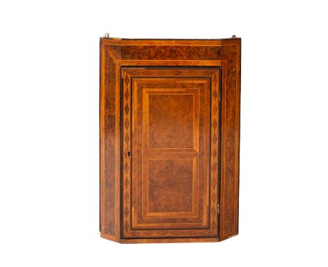 A Craftsman made corner cupboard circa 1930, a small burr walnut and feather-banded hanging corner cupboard with a single doo