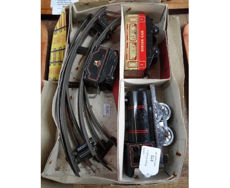 Tinplate clockwork O gauge train set comprising: locomotive, tender and carriage with track in original box by Brimtoy.  (B.P