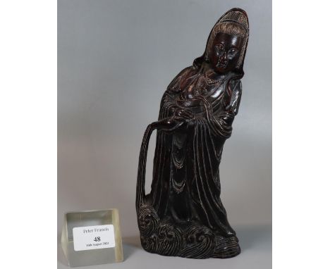 Chinese carved buffalo horn study of 'Guanyan' the Goddess of mercy, here depicted standing above waves and pouring the pure 