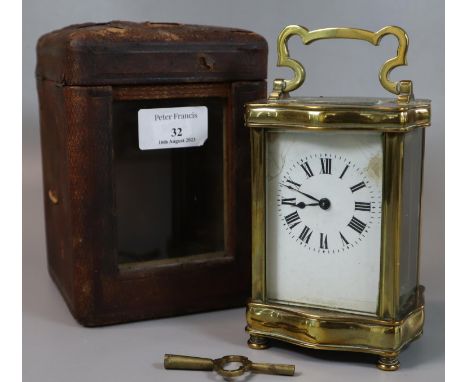 Early 20th Century brass carriage clock in fitted leather case, with enamel face and Roman numerals and key.(B.P. 21% + VAT) 