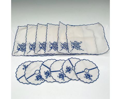 White cotton embroidered with blue leaf and vine design with blue borders. Includes 6 square napkins (6"L x 6"W) and 6 round 